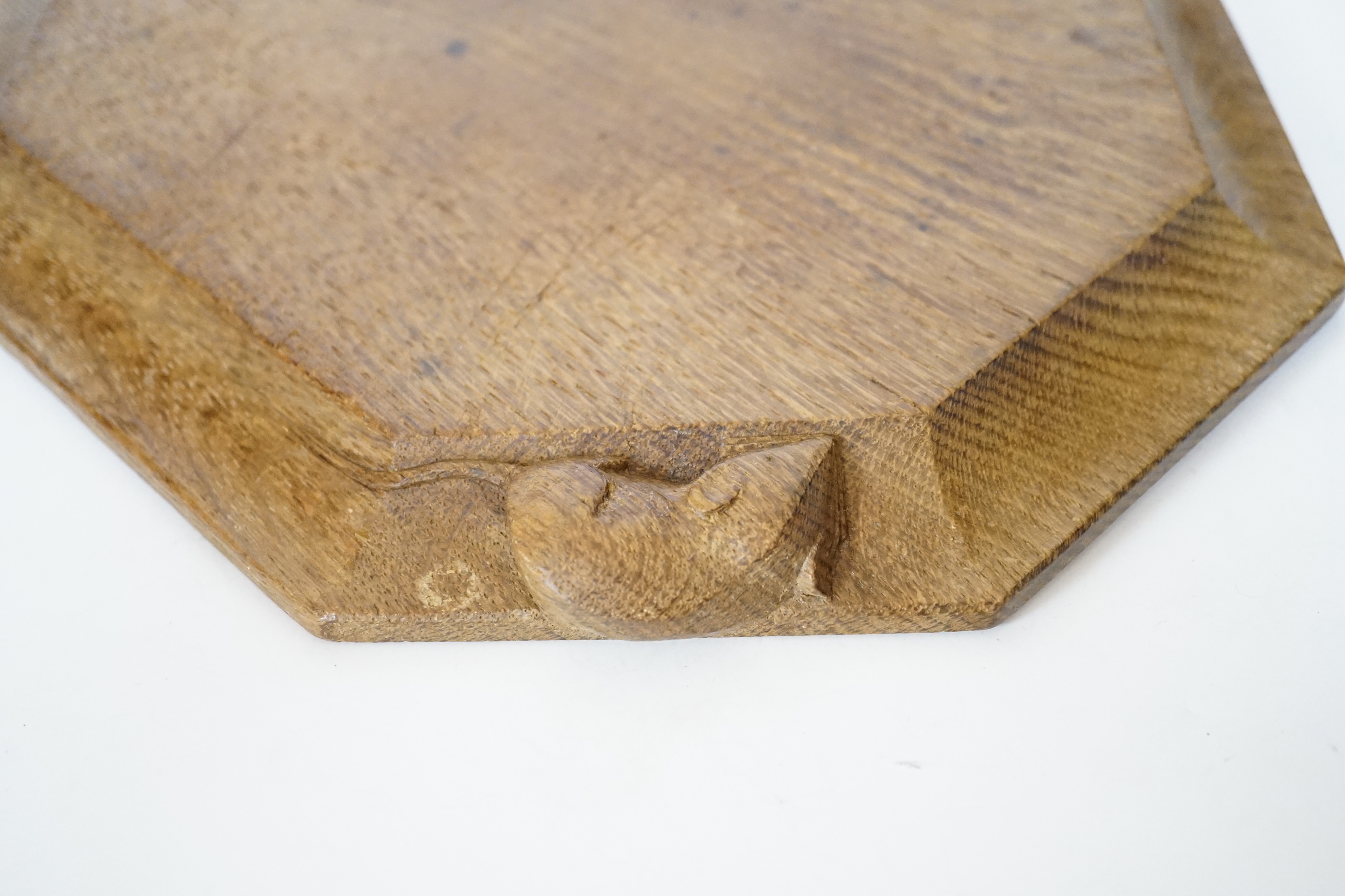 A Robert ‘Mouseman’ Kilburn octagonal carved oak breadboard, 30x25cm